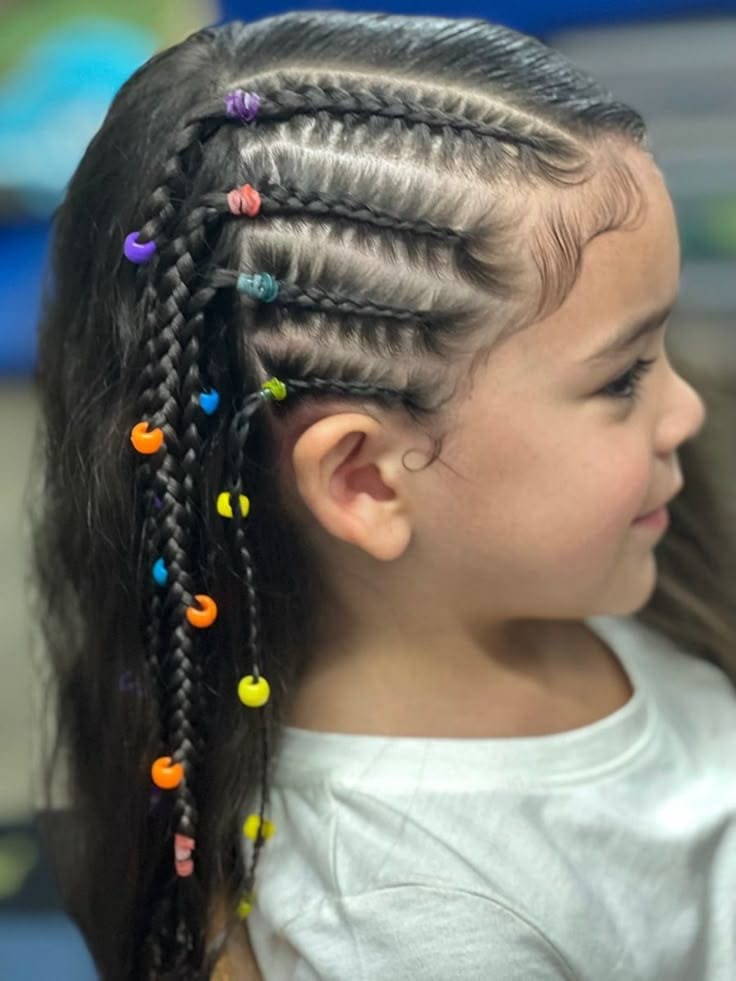 Child's side cornrows finished with colourful rainbow beads.