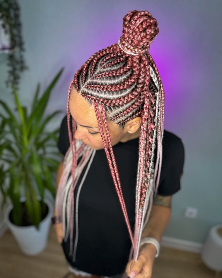 Half-up bun of braids in soft rosé and blush tones, seen from above.